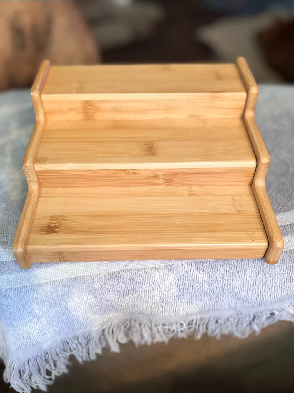 Bamboo 3 tiered expandable spice rack with natural wood grain.